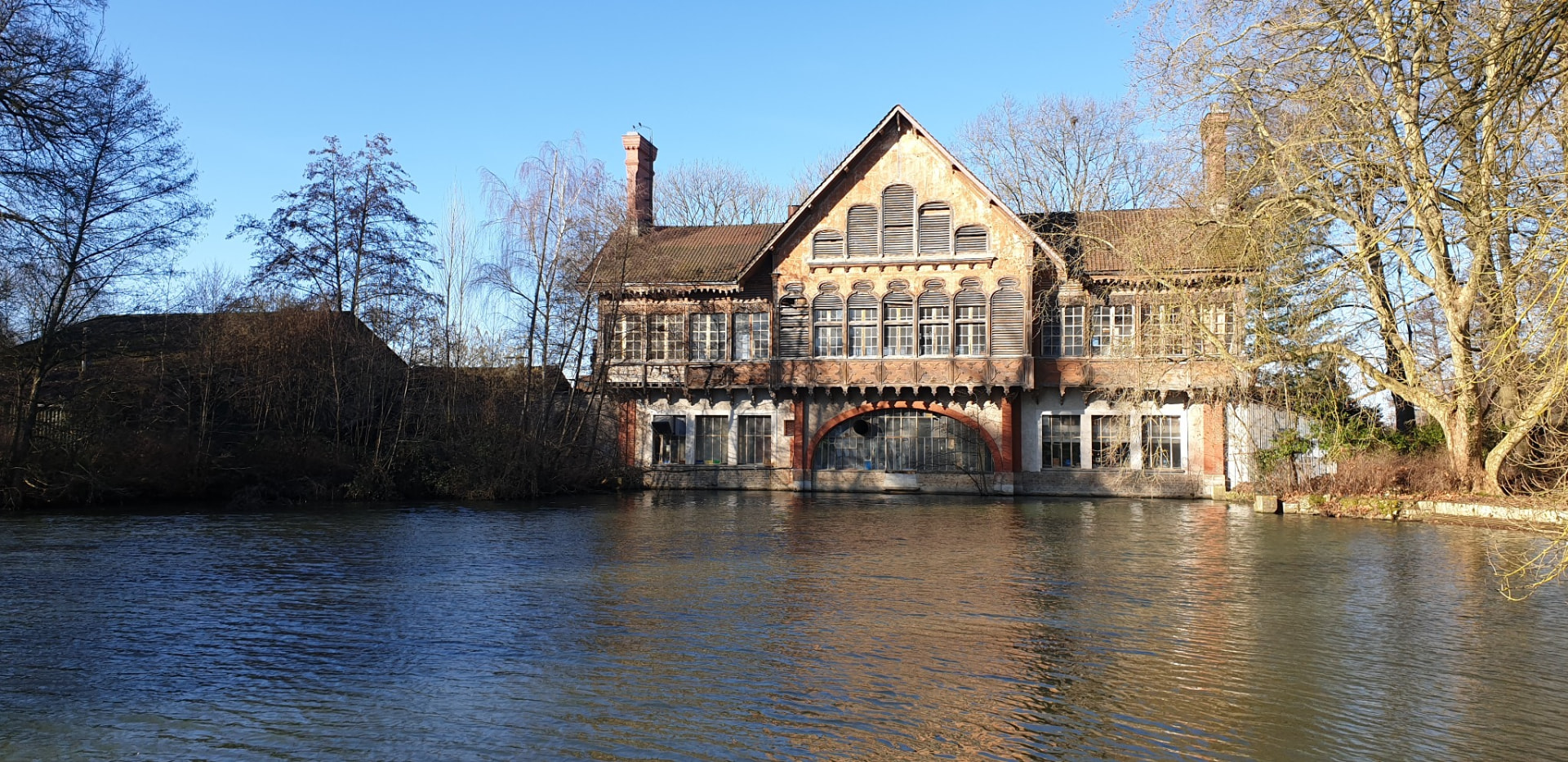 La Buanderie, bâtiment du XIXe siècle en brique et pan de bois, vu depuis l'étang de la Taffarette